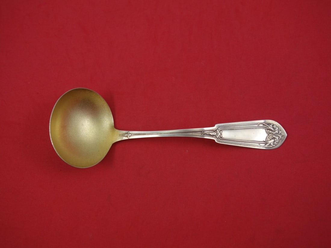 Whiting Fancy Tip sterling gravy ladle gold washed stippled 7 1/2": Whiting Fancy Tip sterling gravy ladle gold washed stippled 7 1/2" Sterling silver gravy ladle in the Fancy Tip pattern by Whiting, featuring a flat handle and a gold washed stippled bowl. This pre-ow