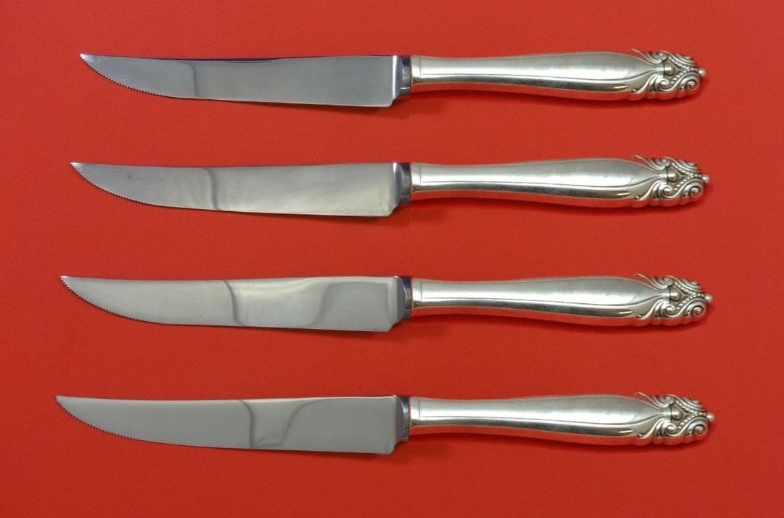 4 Piece Wallace King Christian Sterling Steak Knife Set Custom: 4 Piece Wallace King Christian Sterling Steak Knife Set Custom A 4-piece custom steak knife set in the King Christian pattern by Wallace. The knives feature sterling silver hollow handles with stainle