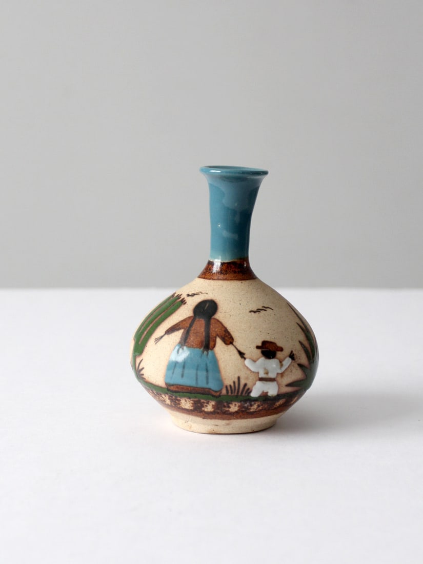 Hand-Painted Vintage Mexican Pottery Vase Family Scene 6 inch: Hand-Painted Vintage Mexican Pottery Vase Family Scene 6 inch This vintage Mexican pottery vase features a charming hand-painted family scene in vibrant turquoise blue, green, and brown. The bottle ne