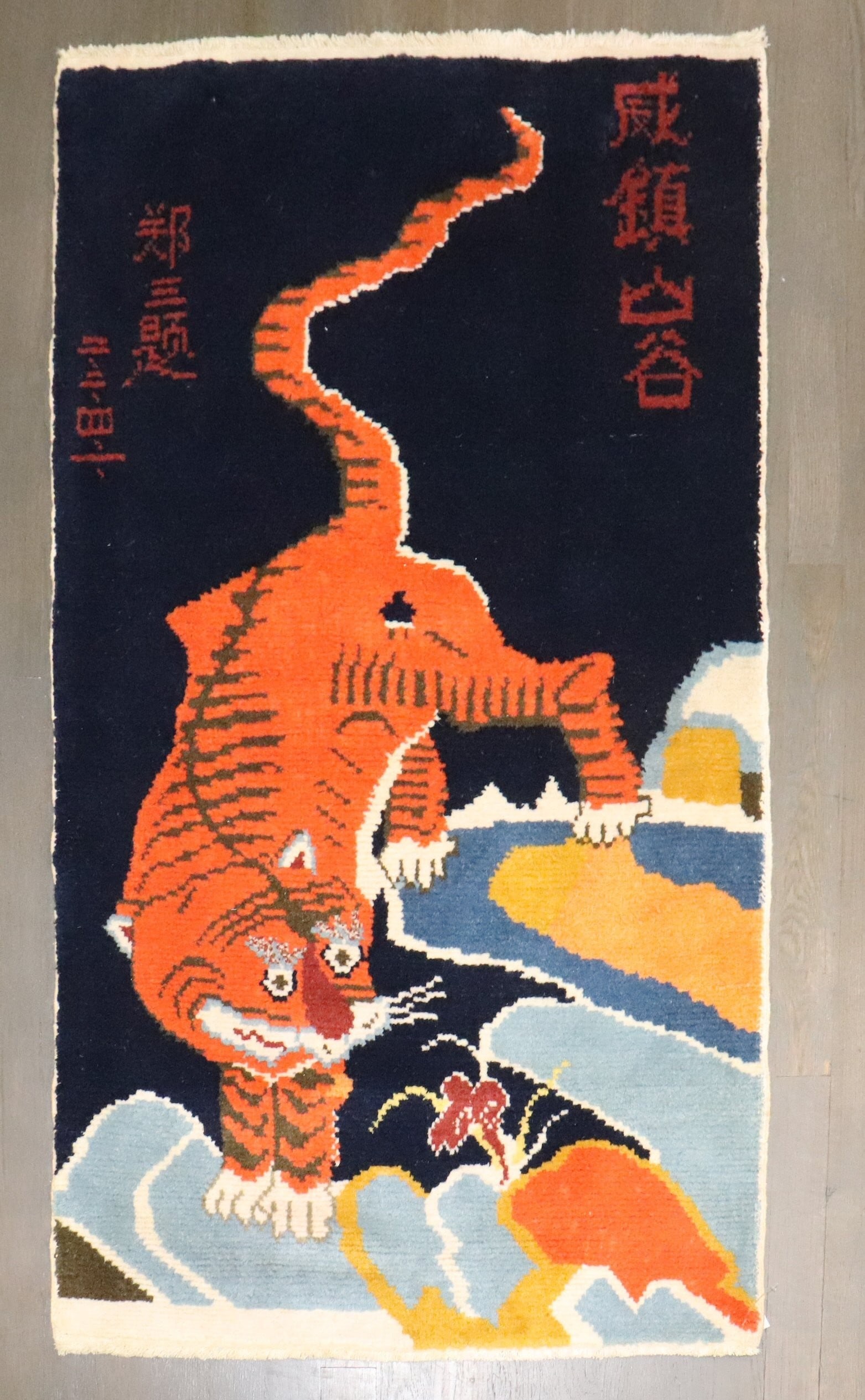 2' 4" x 4' Pictorial Tibetan Small Rug Tiger Motif: 2' 4" x 4' Pictorial Tibetan Small Rug Tiger Motif Late 20th-century Tibetan tiger rug with a pictorial design. This pre-owned small rug reflects traditional Tibetan styling and is presented as a dist