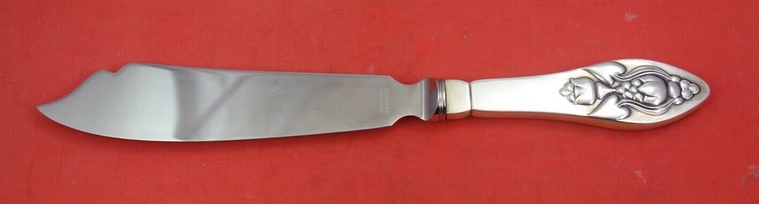 Georg Jensen Fuchsia Sterling Silver Cake Knife 10 5/8 inches: Georg Jensen Fuchsia Sterling Silver Cake Knife 10 5/8 inches Introducing the exquisite Fuchsia cake knife, crafted by renowned maker Georg Jensen. This stunning piece features a hollow handle and is 