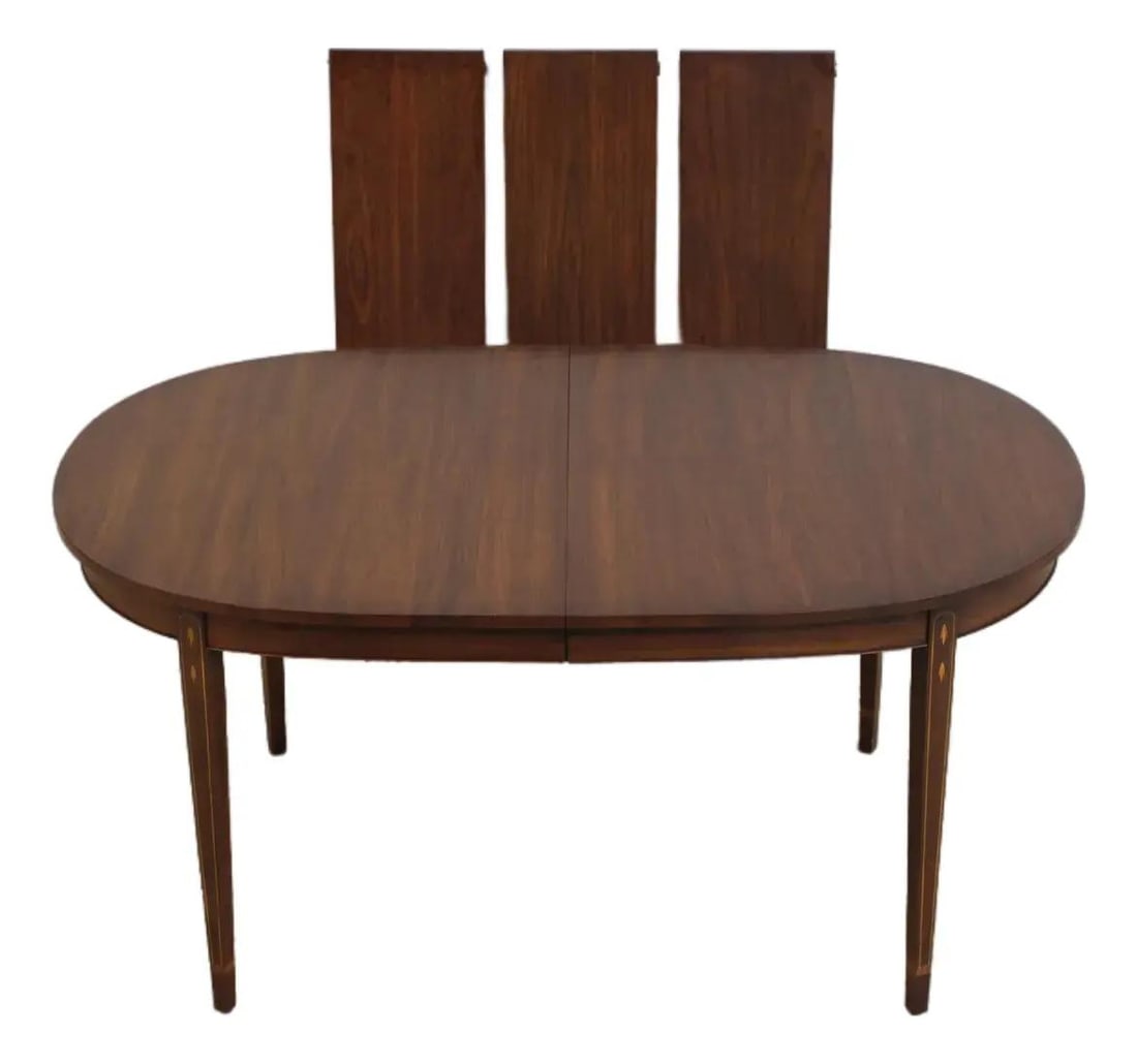 Federal Style Walnut Oval Dining Table by Henkel Harris: Federal Style Walnut Oval Dining Table by Henkel Harris Federal-style oval dining table with walnut construction and inlaid detailing throughout. This c1987 piece features high-quality construction an
