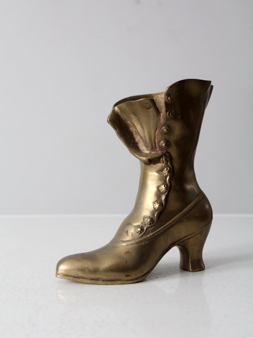 Mid-Century Victorian Brass Boot Vase 8.75 Inches Tall: Mid-Century Victorian Brass Boot Vase 8.75 Inches Tall This exquisite mid-century brass vase is artfully designed in the shape of a Victorian woman's boot, showcasing intricate detailing that highligh