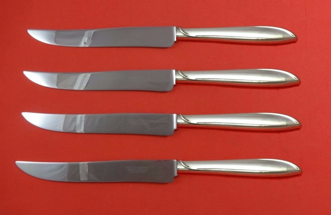 International Sterling Silver Rhythm 4-Piece Texas Steak Knife Set: International Sterling Silver Rhythm 4-Piece Texas Steak Knife Set Enhance your dining experience with this impressive 4-piece Texas-sized steak knife set, crafted in the elegant Silver Rhythm pattern