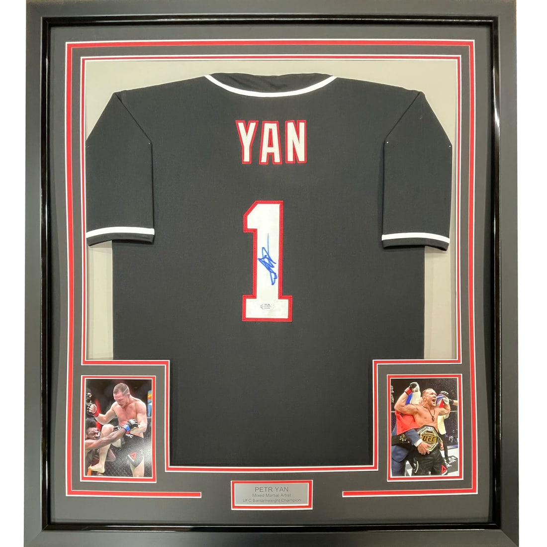 Framed Petr Yan Autographed UFC Jersey Shirt PSA/DNA COA 33x42: Framed Petr Yan Autographed UFC Jersey Shirt PSA/DNA COA 33x42 Showcase your support for UFC with this professionally framed and autographed Petr Yan black jersey shirt. The item features two 5x7 phot