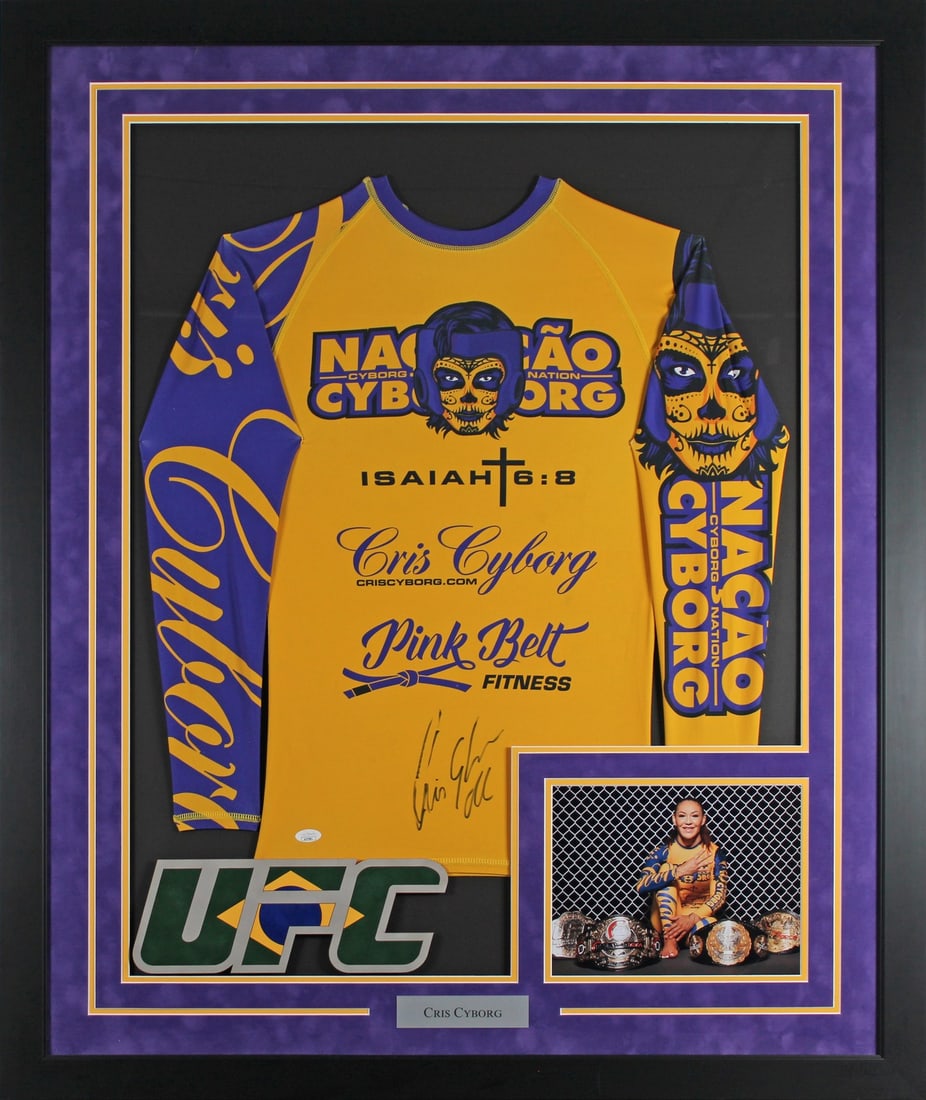 Framed UFC Training Shirt Autographed by Cris Cyborg JSA AJ97881: Framed UFC Training Shirt Autographed by Cris Cyborg JSA AJ97881 Autographed yellow and blue training framed shirt personally signed by Cris Cyborg. This original UFC memorabilia piece comes professio
