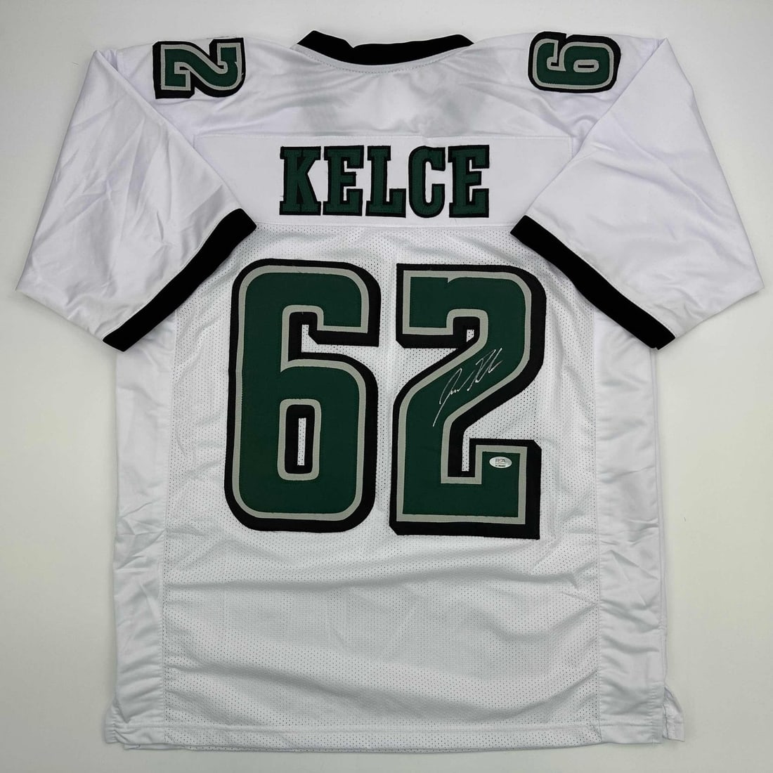 PSA DNA Certified Jason Kelce Signed White Football Jersey XL: PSA DNA Certified Jason Kelce Signed White Football Jersey XL Autographed Jason Kelce white custom jersey with PSA/DNA COA. This original signed collectible is a pre-owned jersey that displays the