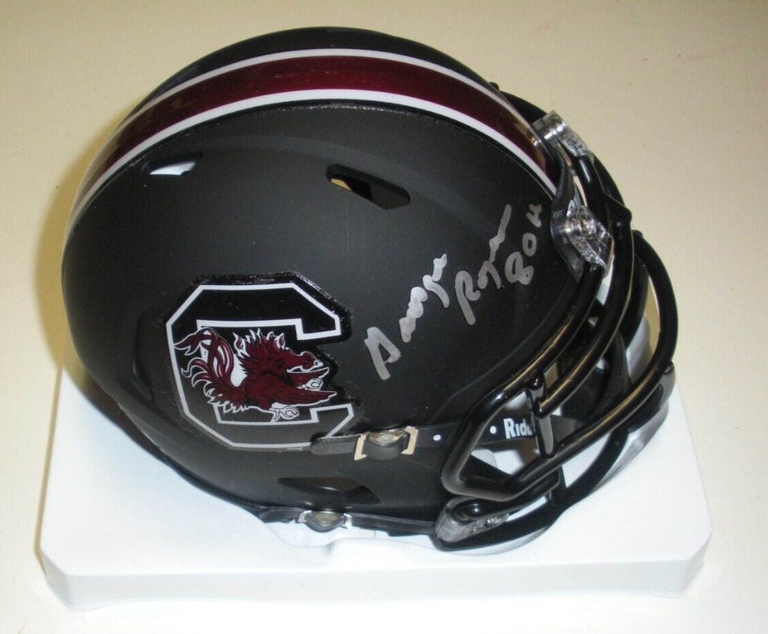 George Rogers Autographed South Carolina Mini Helmet With TRISTAR COA: George Rogers Autographed South Carolina Mini Helmet With TRISTAR COA This mini helmet is signed by George Rogers, commemorating his South Carolina Gamecocks Heisman Trophy achievement in 1980. The he