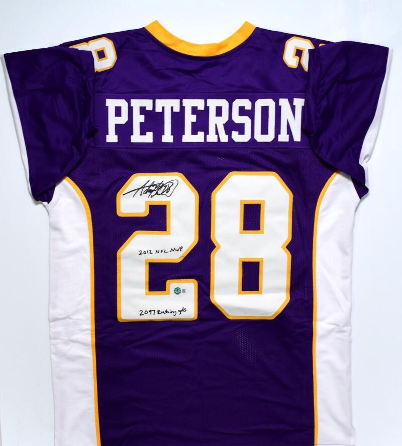 Adrian Peterson Autographed Minnesota Vikings Jersey Beckett Hologram 2 Inscriptions: Adrian Peterson Autographed Minnesota Vikings Jersey Beckett Hologram 2 Inscriptions This is an original Adrian Peterson signed purple pro style jersey featuring two inscriptions. It is associated wit
