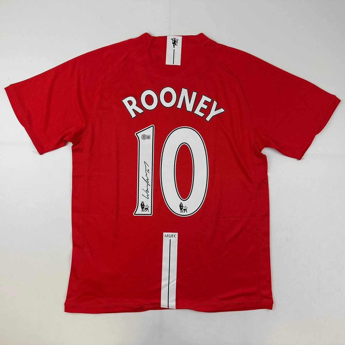 2008 Manchester United Red Jersey Signed by Wayne Rooney Beckett COA: 2008 Manchester United Red Jersey Signed by Wayne Rooney Beckett COA Pre-owned red 2008 Manchester United jersey signed by Wayne Rooney. This original autographed jersey comes with third-party authent