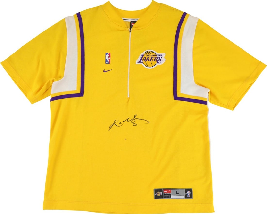 Autographed Lakers Gold Shooting Shirt Jersey by Kobe Bryant with PSA Letter: Autographed Lakers Gold Shooting Shirt Jersey by Kobe Bryant with PSA Letter This Los Angeles Lakers gold warmup shooting shirt jersey is signed by Kobe Bryant, featuring his signature with the number