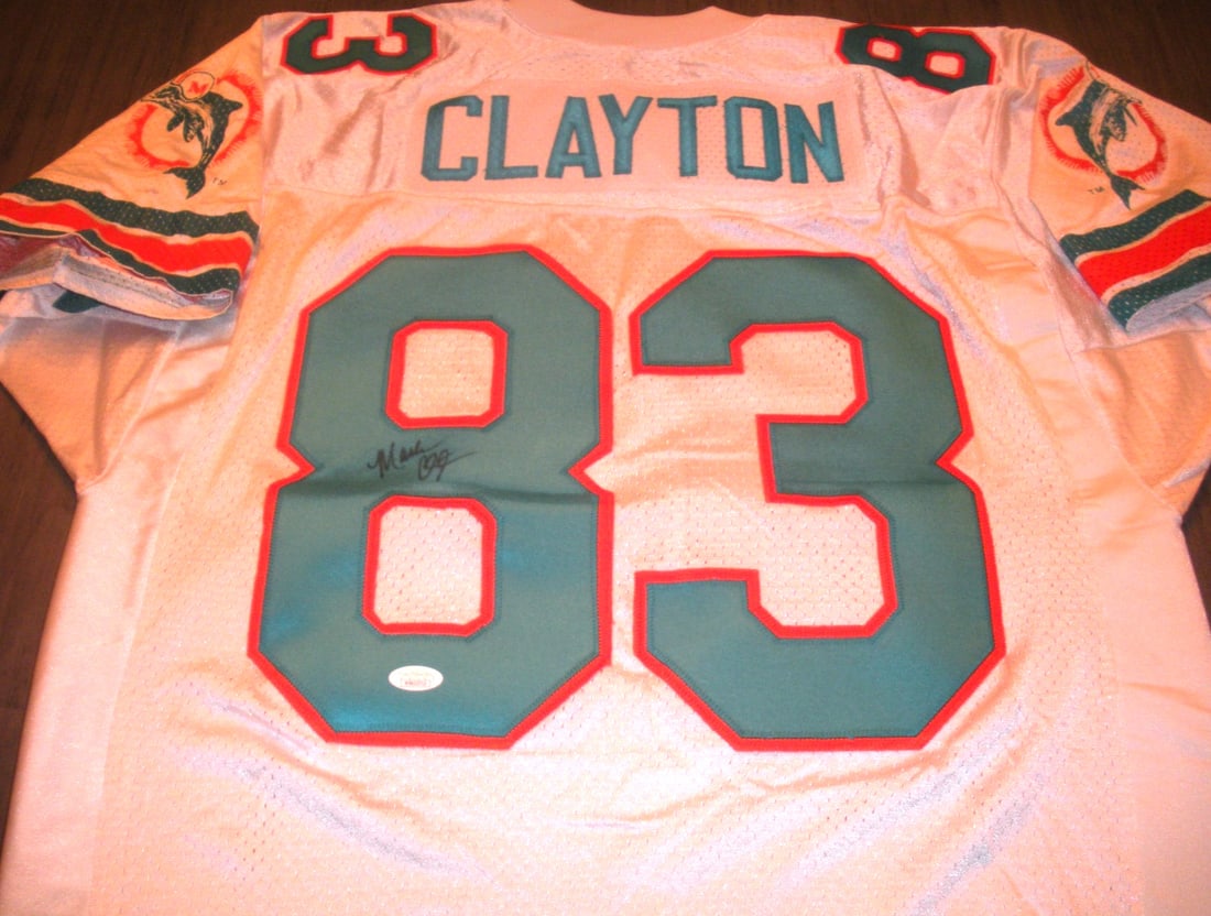 Signed Proline Miami Dolphins Jersey by Mark Clayton with JSA COA: Signed Proline Miami Dolphins Jersey by Mark Clayton with JSA COA This official licensed Proline Miami Dolphins jersey is signed by Mark Clayton. It comes with JSA/COA authentication, making it a rare
