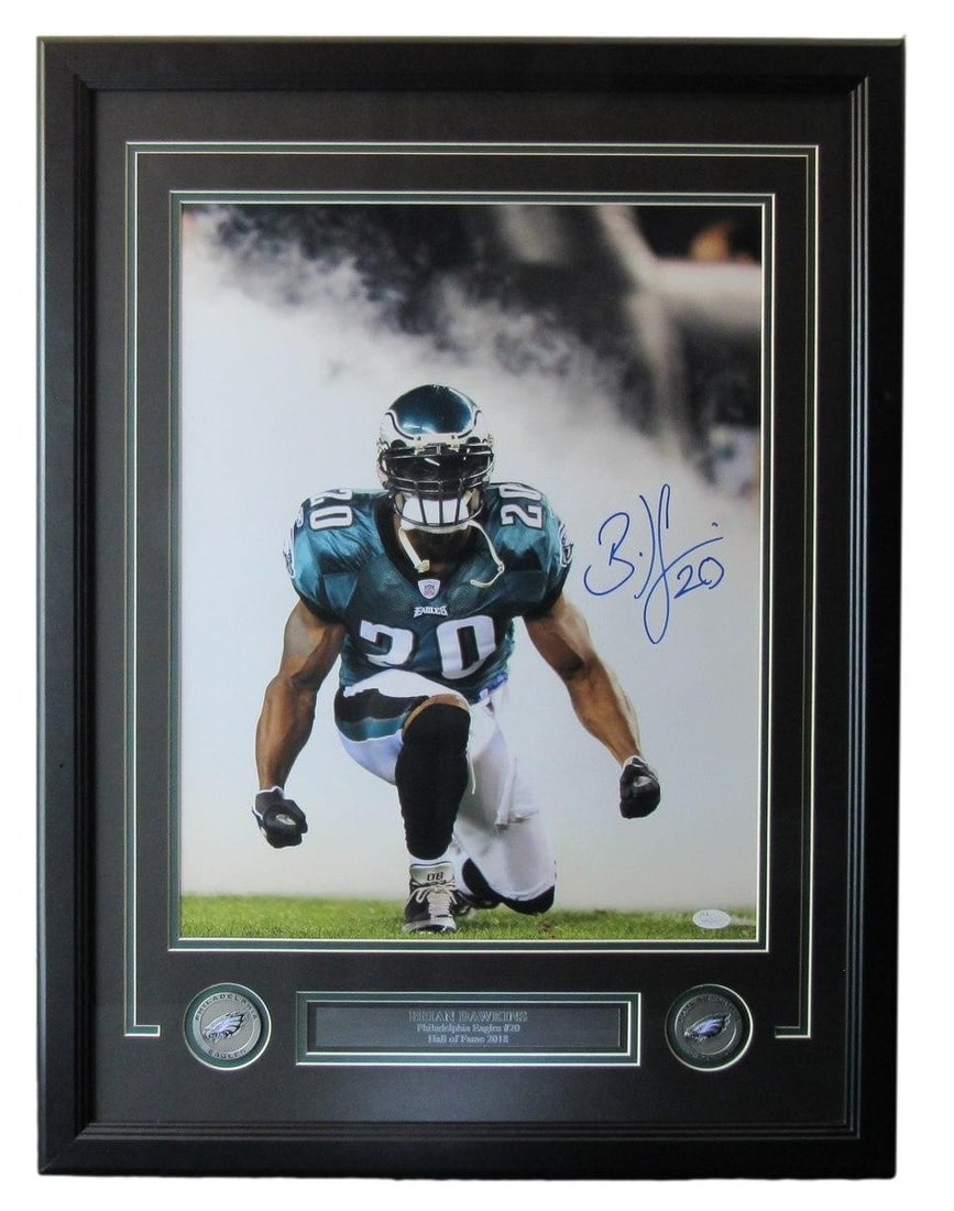 Framed 16x20 Brian Dawkins Autographed Photo With HOF Inscription JSA Authenticated: Framed 16x20 Brian Dawkins Autographed Photo With HOF Inscription JSA Authenticated This framed 16x20 photo features an authentic signature and inscription by Brian Dawkins, one of the most iconic pla