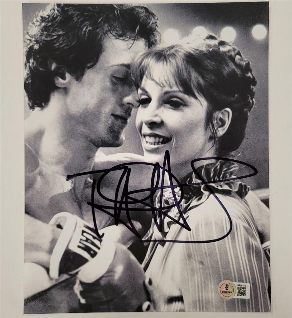 8x10 Rocky Photograph Signed by Talia Shire as Adrian Beckett Authenticated: 8x10 Rocky Photograph Signed by Talia Shire as Adrian Beckett Authenticated This is an original 8x10 photograph from the movie Rocky, hand-signed by Talia Shire, who portrayed Adrian Balboa. The autog