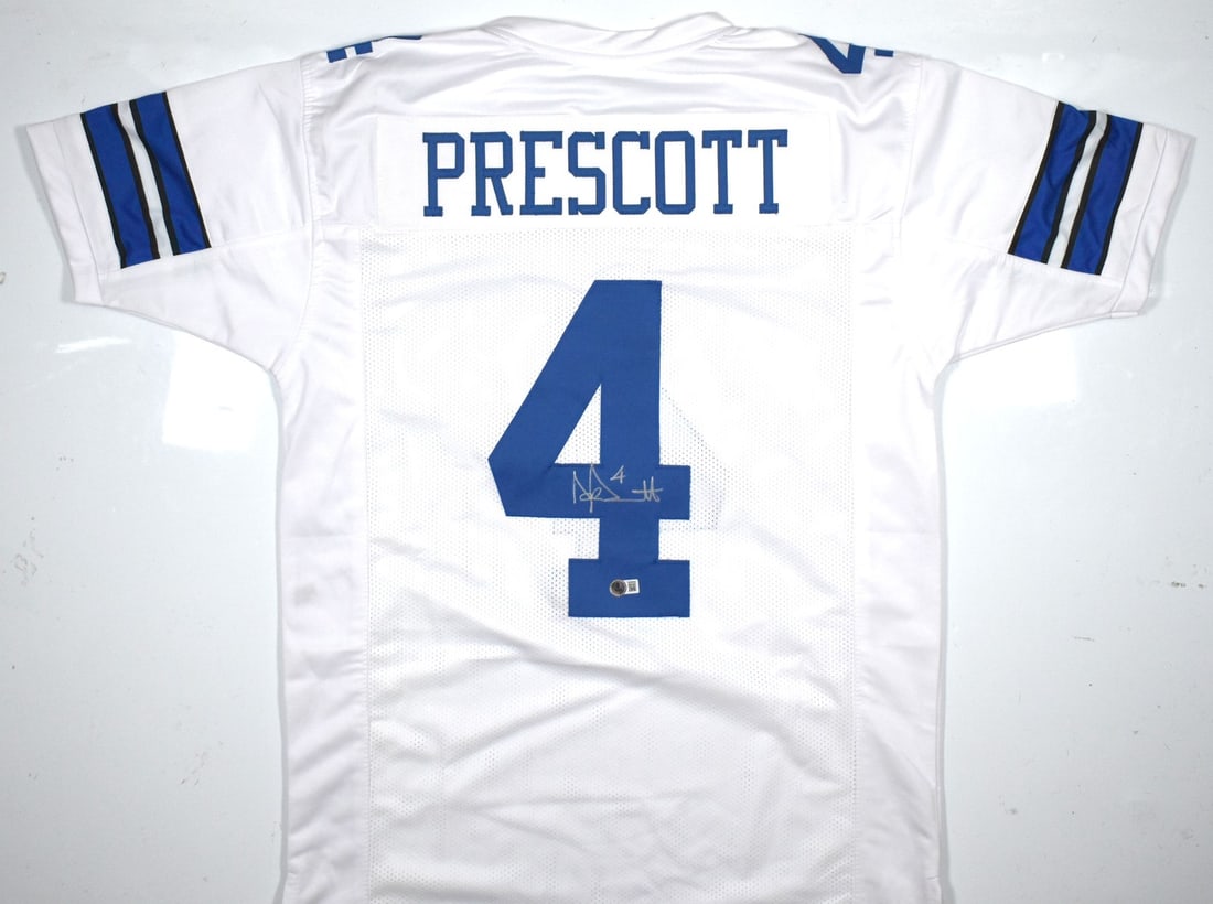 Signed Dak Prescott White Football Jersey Beckett Hologram Dallas Cowboys: Signed Dak Prescott White Football Jersey Beckett Hologram Dallas Cowboys This is a white pro style football jersey autographed by Dak Prescott. The jersey features a Beckett Witness authentication ho