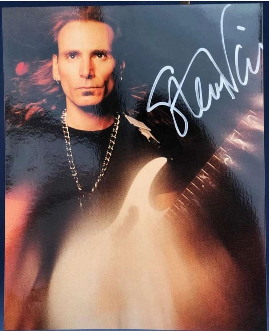Autographed Steve Vai 8x10 Color Photo REAL LOA Roger Epperson: Autographed Steve Vai 8x10 Color Photo REAL LOA Roger Epperson Autographed color photograph signed by guitarist Steve Vai. The piece includes a Letter of Authenticity from REAL and is authenticated by