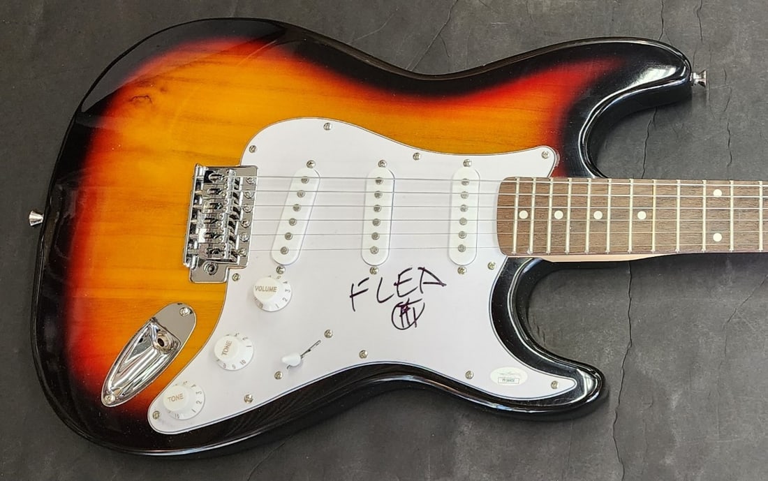 Flea signed RHCP sunburst electric guitar JSA LOA YY54408: Flea signed RHCP sunburst electric guitar JSA LOA YY54408 This is an original sunburst electric guitar hand-signed by Flea of the Red Hot Chili Peppers. The guitar comes with a letter of authenticity 