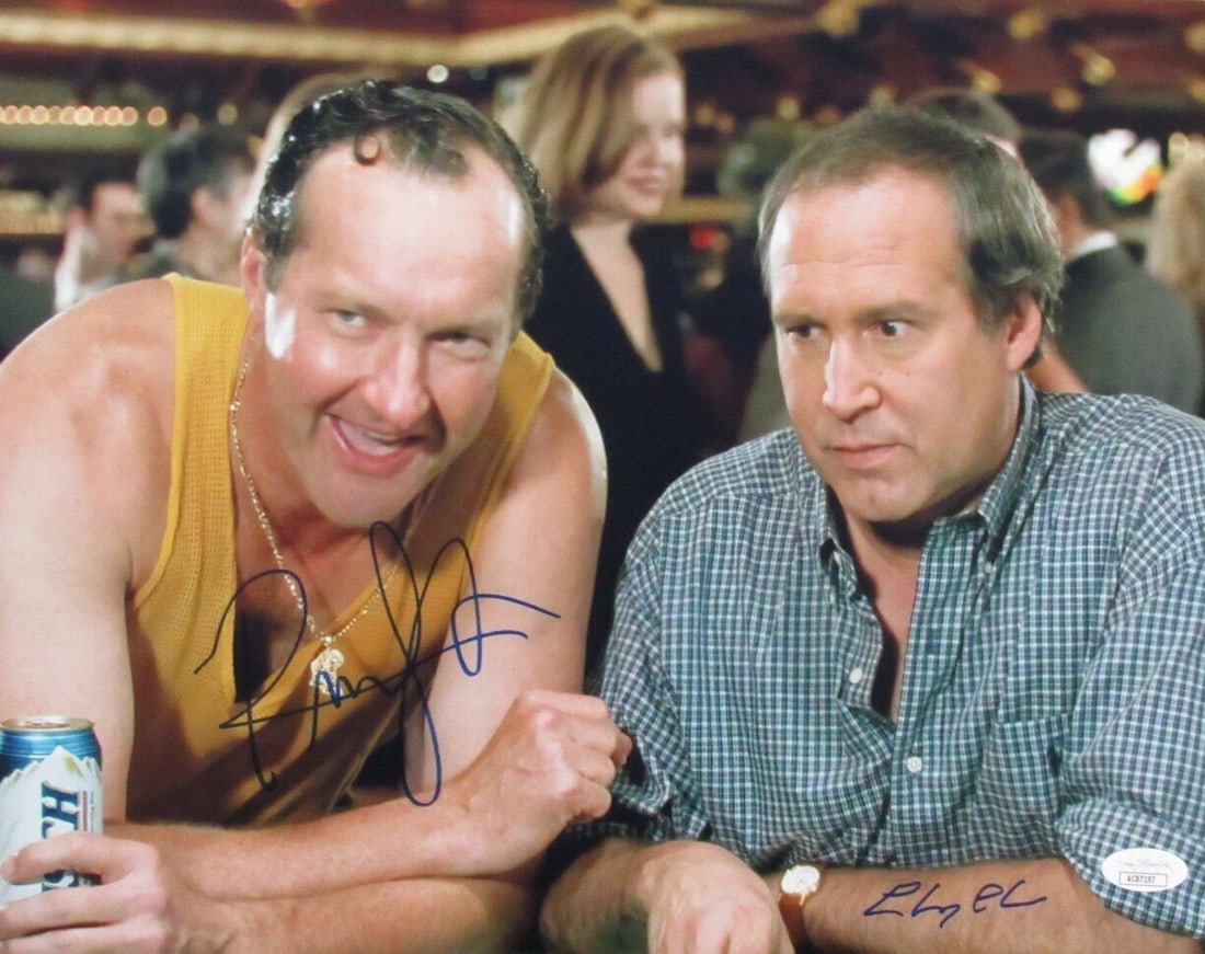 Chevy Chase Randy Quaid Dual-Signed 11x14 Photo Vegas Vacation JSA Authenticated: Chevy Chase Randy Quaid Dual-Signed 11x14 Photo Vegas Vacation JSA Authenticated This is a dual-autographed 11x14 photo featuring Chevy Chase and Randy Quaid from the classic film "Vegas Vacation." Th