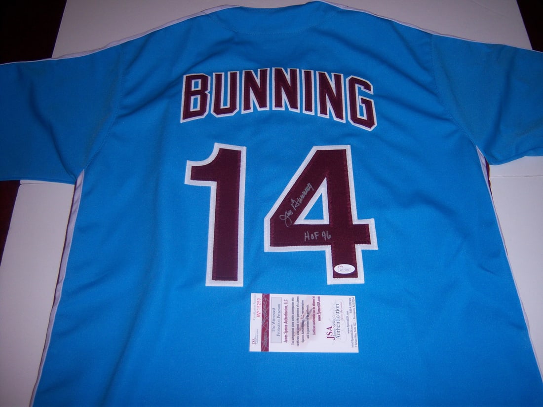 Signed Jim Bunning Phillies Jersey JSA COA HOF 96: Signed Jim Bunning Phillies Jersey JSA COA HOF 96 Hand-signed Philadelphia Phillies jersey featuring Jim Bunning with HOF 96 notation. This original baseball memorabilia piece is pre-owned and comes w
