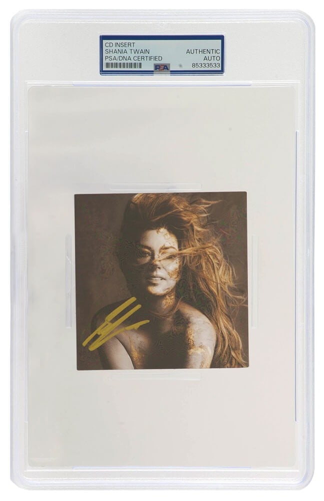 Shania Twain Signed Queen Of Me CD Insert PSA/DNA 4x4 in Gold: Shania Twain Signed Queen Of Me CD Insert PSA/DNA 4x4 in Gold This is a signed 4x4 CD insert of Shania Twain's 'Queen Of Me', featuring her autograph in striking gold ink. The insert is encapsulated f