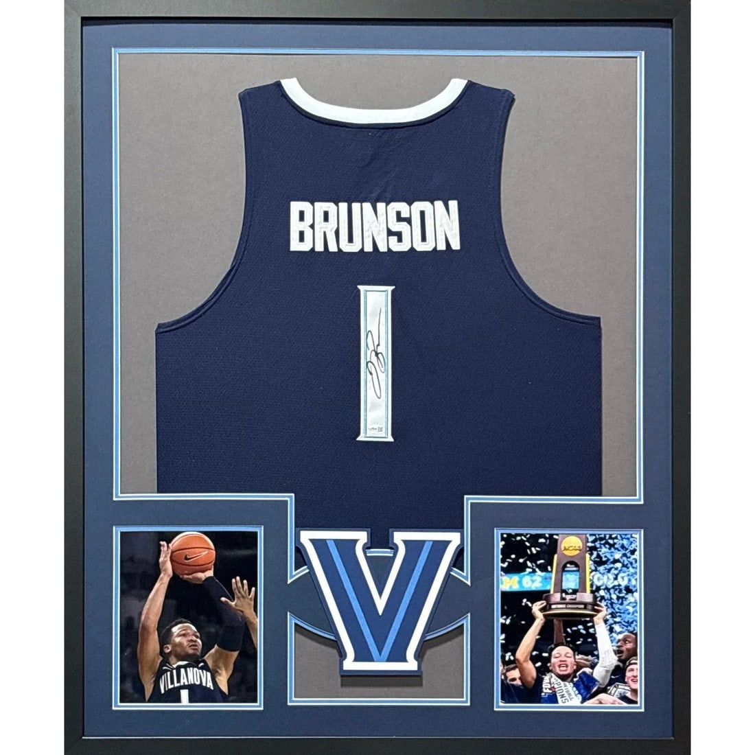 Framed Jalen Brunson Autographed Knicks Jersey JSA Certified: Framed Jalen Brunson Autographed Knicks Jersey JSA Certified Framed Jalen Brunson autographed jersey featuring Knicks and Villanova references. The signature is authenticated by JSA and includes a tam
