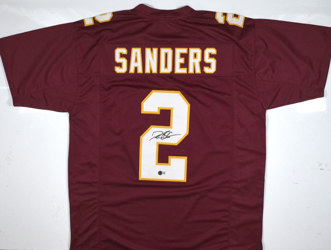 Beckett BAS Deion Sanders Signed Florida State Seminoles Jersey: Beckett BAS Deion Sanders Signed Florida State Seminoles Jersey Autographed maroon college-style jersey signed by Deion Sanders. The item is pre-owned and includes a Beckett W hologram. Country of ori