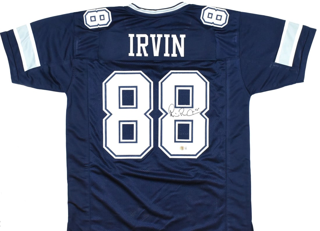 Michael Irvin Signed Blue Football Jersey Beckett Authenticated: Michael Irvin Signed Blue Football Jersey Beckett Authenticated This blue pro style football jersey is autographed by Michael Irvin and features a Beckett witness hologram. It is an original item repr