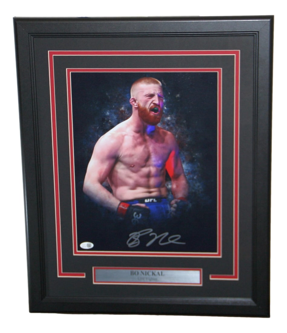 Bo Nickal Signed 11x14 Photo Framed JSA Certified UFC: Bo Nickal Signed 11x14 Photo Framed JSA Certified UFC This is an original framed 11x14 photo of Bo Nickal, a prominent mixed martial arts fighter in the UFC. The photo features his authentic signature