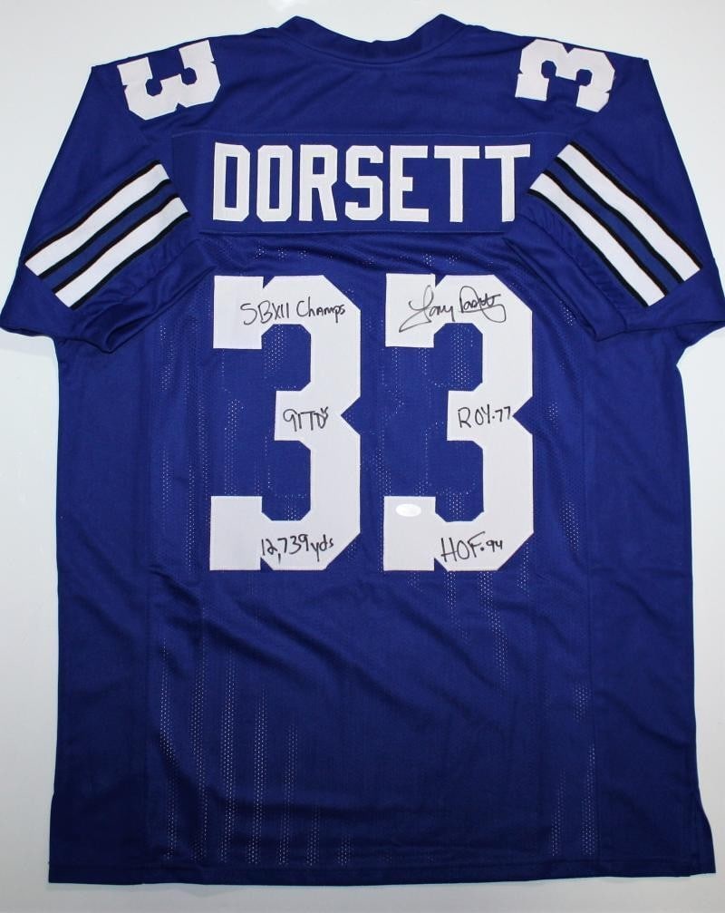 Blue Dallas Cowboys jersey signed by Tony Dorsett with 5 inscriptions JSA: Blue Dallas Cowboys jersey signed by Tony Dorsett with 5 inscriptions JSA Autographed Tony Dorsett blue pro style jersey with 5 inscriptions. The jersey is original, represents the Dallas Cowboys, and