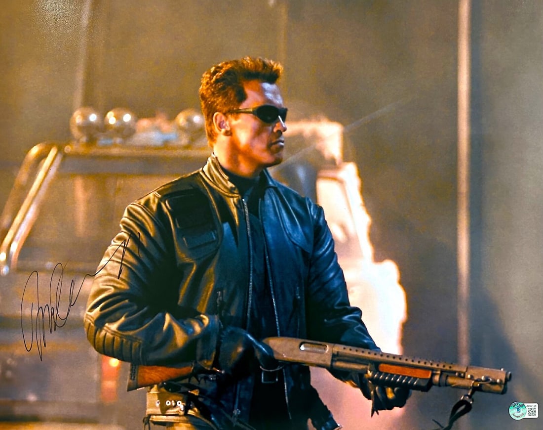 Arnold Schwarzenegger Signed Terminator 16x20 Photo with Beckett LOA: Arnold Schwarzenegger Signed Terminator 16x20 Photo with Beckett LOA This is an autographed 16x20 photograph of Arnold Schwarzenegger, signed in black permanent marker. The photograph features the ico