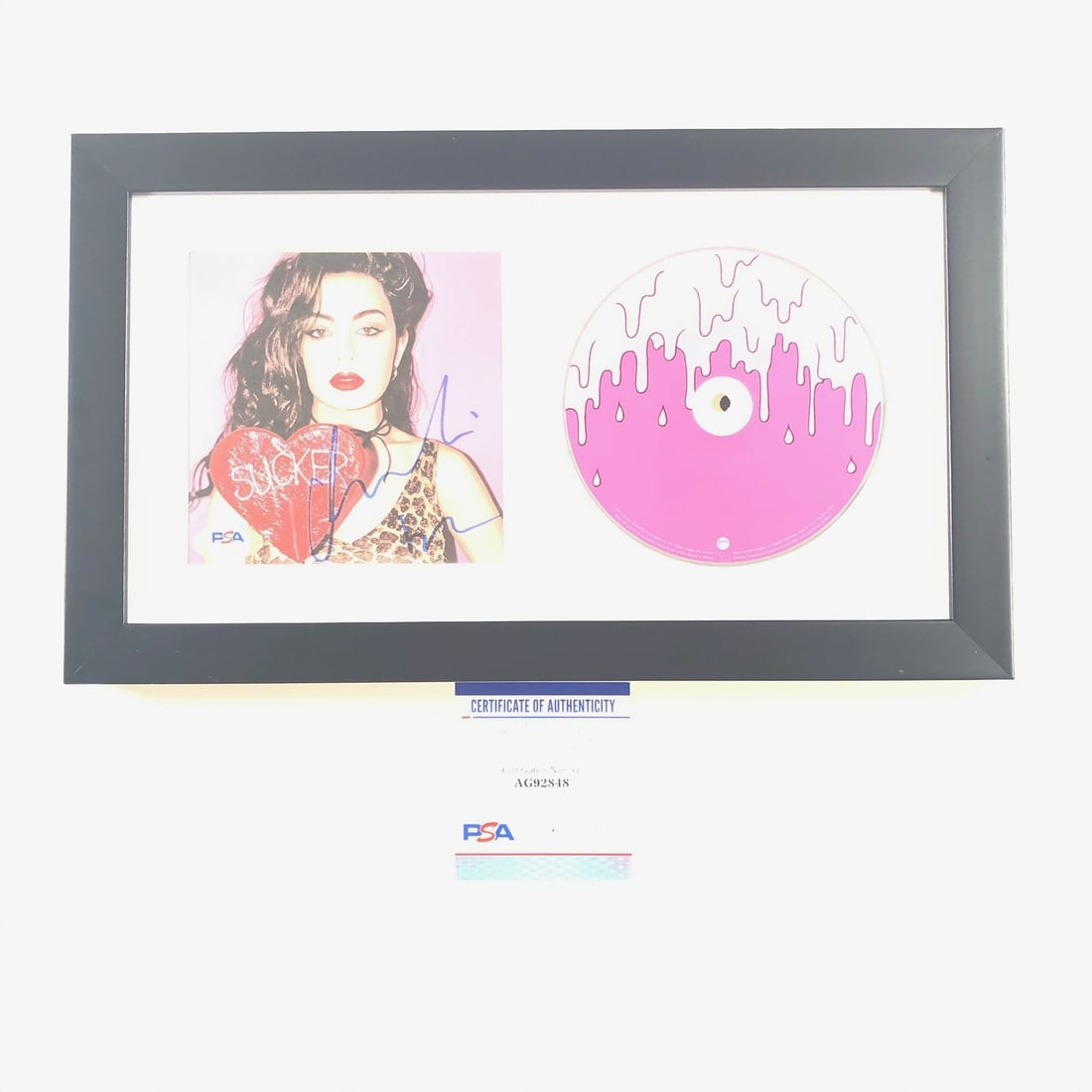 Framed Charli XCX Sucker CD Cover PSA DNA Signed Autograph: Framed Charli XCX Sucker CD Cover PSA DNA Signed Autograph This framed CD cover features the album 'Sucker' signed by Charli XCX. The autograph has been authenticated by PSA/DNA. The item includes bot