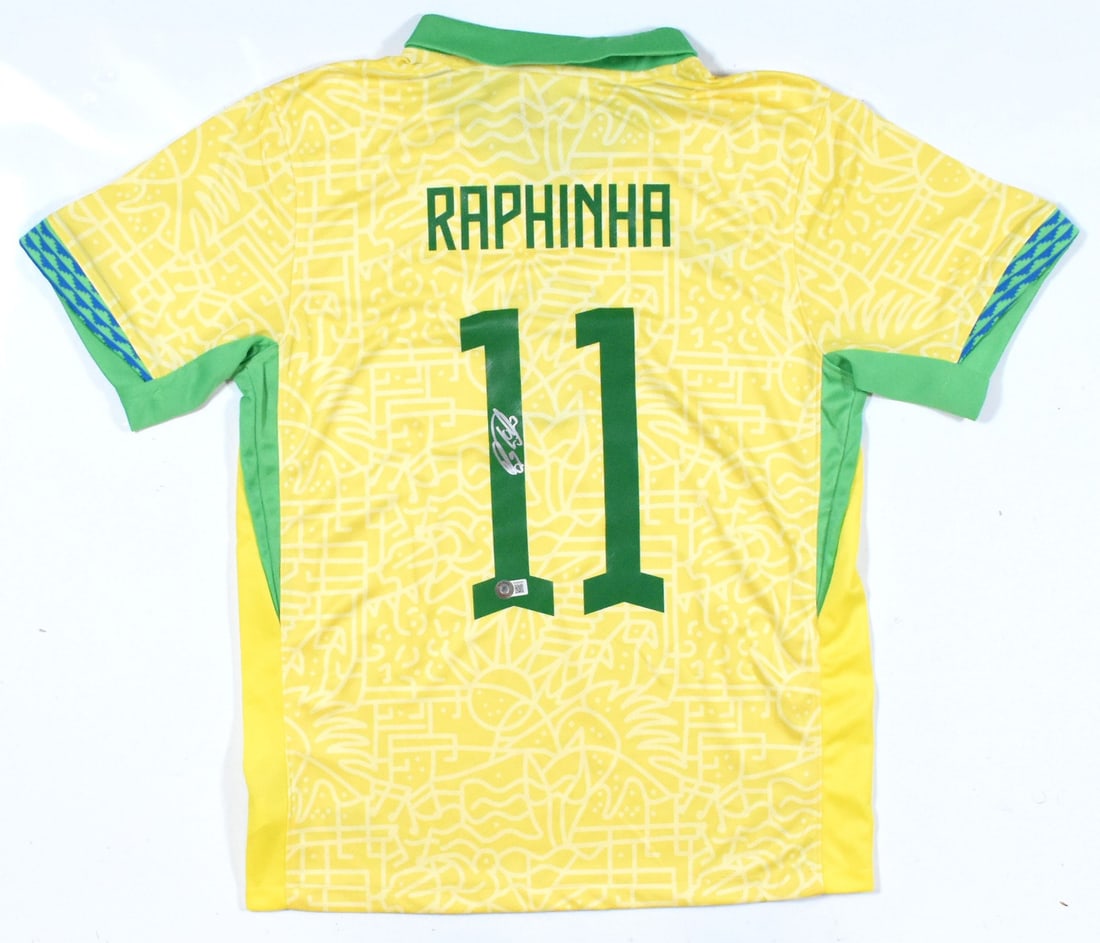Brazil Home Jersey #11 Signed by Raphinha Beckett Hologram: Brazil Home Jersey #11 Signed by Raphinha Beckett Hologram This is a Brazil home soccer jersey featuring the number 11 and autographed by Raphinha. The jersey includes a Beckett hologram for added aut