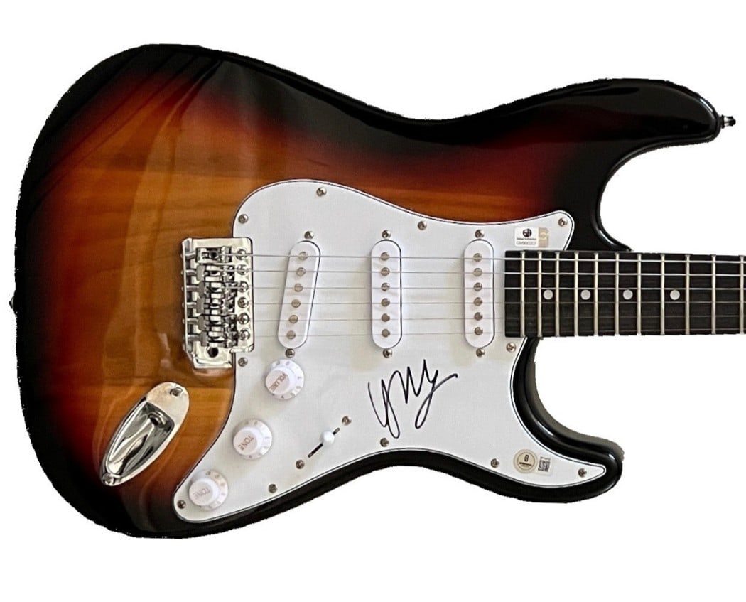 Harry Connick Jr Autographed Guitar Beckett Authenticated Collectible: Harry Connick Jr Autographed Guitar Beckett Authenticated Collectible This is an original electric guitar autographed by Harry Connick Jr., featuring the iconic signature 'A Wink And A Smile.' The aut