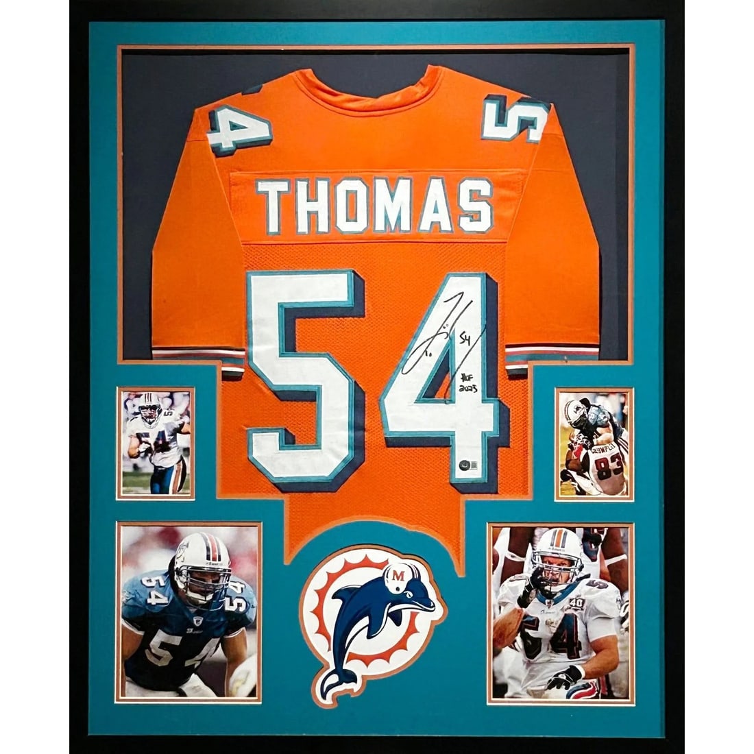 Framed Miami Dolphins Jersey Signed by Zach Thomas Beckett Authenticated: Framed Miami Dolphins Jersey Signed by Zach Thomas Beckett Authenticated Framed Zach Thomas signed jersey for the Miami Dolphins. This autographed display features detailed framing with team logo pres