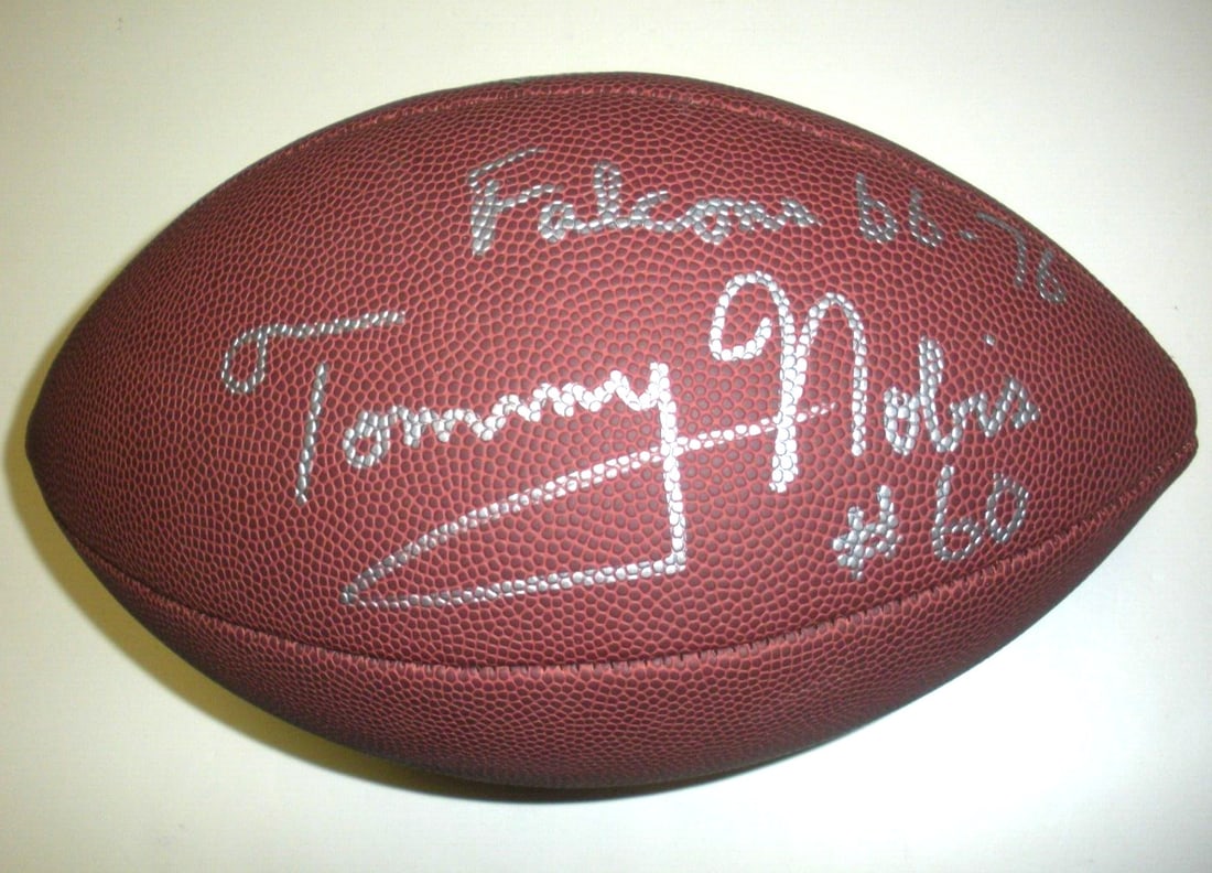 Signed Football With COA Featuring Tommy Nobis Texas and Falcons 66-76: Signed Football With COA Featuring Tommy Nobis Texas and Falcons 66-76 This is an original football signed by Tommy Nobis, known for his career with the Texas Longhorns and the Atlanta Falcons from 19
