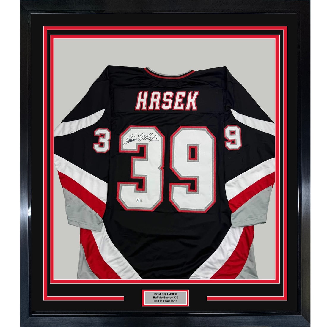 Framed Autographed Dominik Hasek Buffalo Sabres Jersey with BAS COA: Framed Autographed Dominik Hasek Buffalo Sabres Jersey with BAS COA Celebrate the legacy of Dominik Hasek with this stunning framed autographed black jersey from the Buffalo Sabres. Measuring 35x39 in