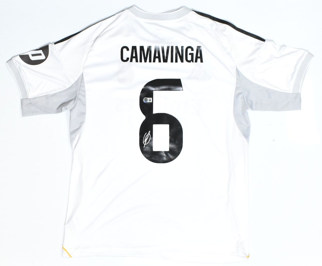 Real Madrid Home Jersey Camavinga Autographed Beckett Holo #6: Real Madrid Home Jersey Camavinga Autographed Beckett Holo #6 This Real Madrid home soccer jersey features the number 6 and has been autographed by Camavinga. The jersey is an original item and comes 