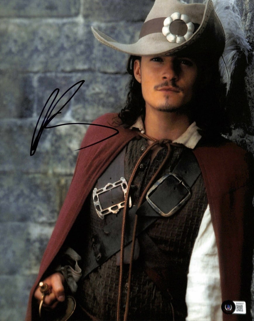 Orlando Bloom Signed 11x14 Pirates of the Caribbean Photo Beckett Certified: Orlando Bloom Signed 11x14 Pirates of the Caribbean Photo Beckett Certified This stunning 11x14 photograph captures Orlando Bloom as Will Turner from the iconic movie series Pirates of the Caribbean. 