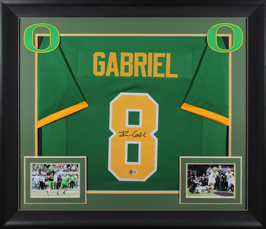 Framed Green Pro Style Jersey Signed by Dillon Gabriel Beckett Witnessed: Framed Green Pro Style Jersey Signed by Dillon Gabriel Beckett Witnessed Autographed green pro style framed jersey personally signed by Dillon Gabriel of the Oregon Ducks. It is an original item with 
