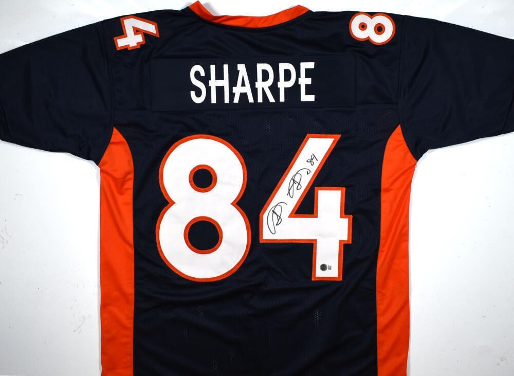 Signed Denver Broncos Football Jersey Shannon Sharpe Beckett Hologram: Signed Denver Broncos Football Jersey Shannon Sharpe Beckett Hologram Autographed blue pro style football jersey signed by Shannon Sharpe. The jersey is associated with the Denver Broncos and is an or