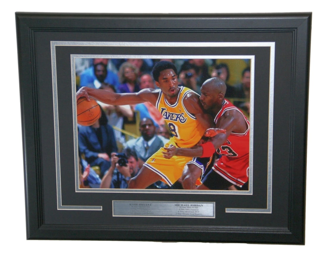 Framed 14x11 NBA Basketball Photo of Kobe Bryant and Michael Jordan: Framed 14x11 NBA Basketball Photo of Kobe Bryant and Michael Jordan Framed NBA photo featuring Kobe Bryant and Michael Jordan. This pre-owned basketball collectible presents both players in a display-