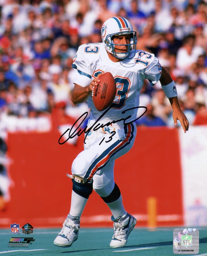 Dan Marino Signed Miami Dolphins 8x10 Action Photo with COA: Dan Marino Signed Miami Dolphins 8x10 Action Photo with COA This is a stunning 8x10 action photograph featuring Dan Marino in a Miami Dolphins roll-out white jersey. The photo is a tribute to one of t