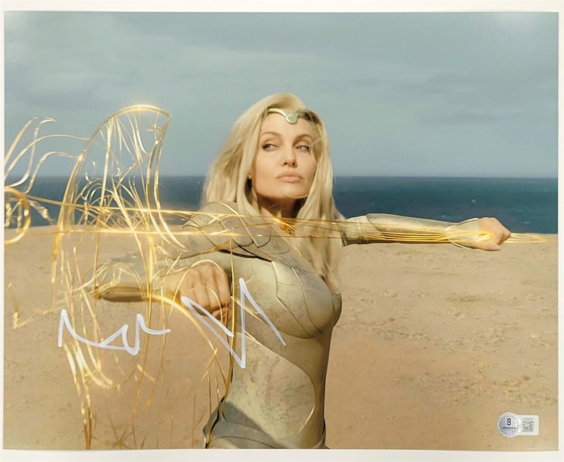 11x14 Thena Eternals Photo Signed by Angelina Jolie Beckett Authenticated: 11x14 Thena Eternals Photo Signed by Angelina Jolie Beckett Authenticated This is an original 11x14 photograph of Thena from Marvel's Eternals, hand-signed by Angelina Jolie. The autograph is authenti
