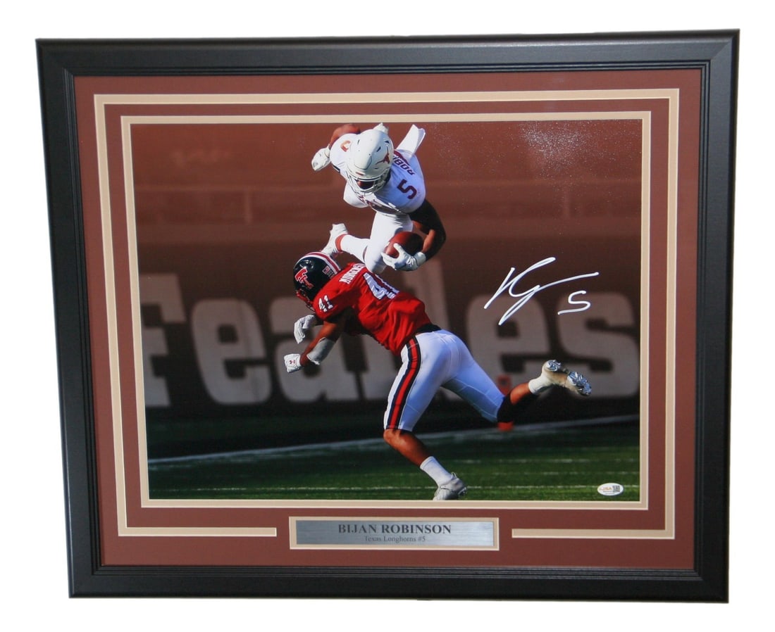 Framed 20x16 Texas Longhorns Photo Signed by Bijan Robinson JSA: Framed 20x16 Texas Longhorns Photo Signed by Bijan Robinson JSA Framed signed photo of Bijan Robinson featuring the Texas Longhorns. This original football collectible is authenticated by James Spence