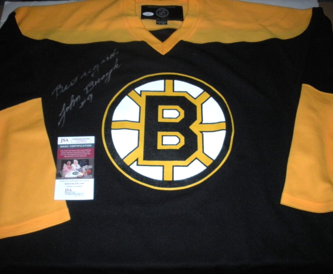 Johnny Bucyk Signed Boston Bruins NHL Jersey with JSA/COA: Johnny Bucyk Signed Boston Bruins NHL Jersey with JSA/COA This official licensed NHL jersey features the iconic design of Johnny Bucyk, a legendary player for the Boston Bruins. Authentically signed b