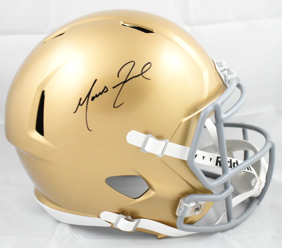 Notre Dame Full Size Speed Helmet Signed by Marcus Freeman Beckett Hologram: Notre Dame Full Size Speed Helmet Signed by Marcus Freeman Beckett Hologram This is a pre-owned full-size Notre Dame Fighting Irish Speed helmet autographed by Marcus Freeman. The helmet comes with a 