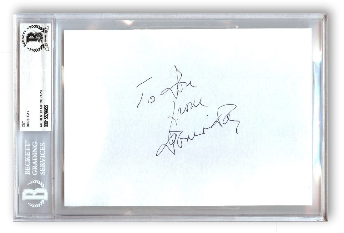 Doris Day Authentic Signed Cut Signature Beckett Authenticated Slab Case: Doris Day Authentic Signed Cut Signature Beckett Authenticated Slab Case This is a Doris Day autographed cut signature, featuring the signature of the renowned actress and singer. The autograph is aut