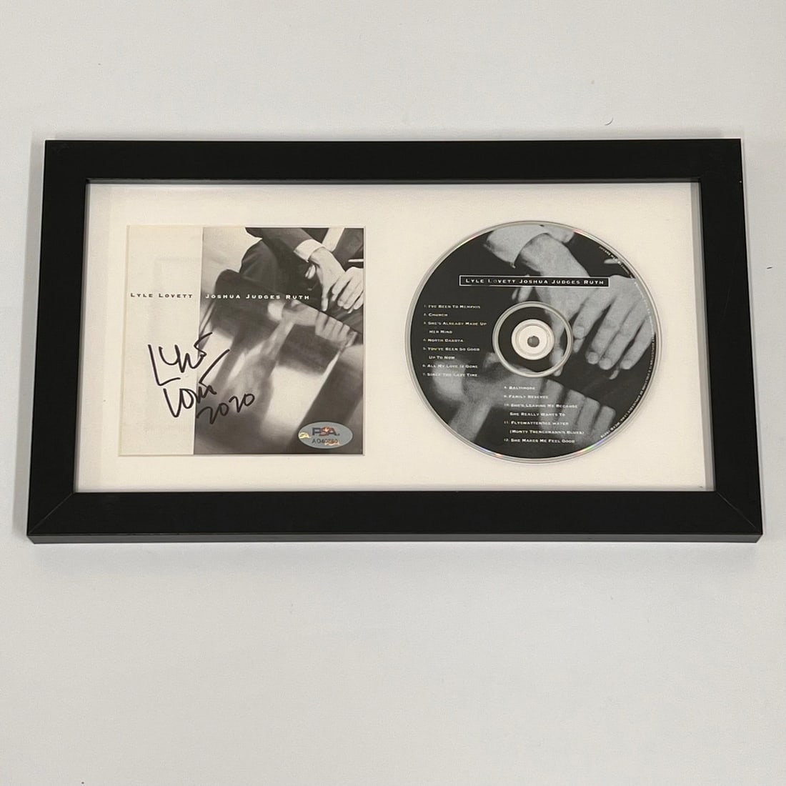 Lyle Lovett Framed Signed Joshua Judges Ruth CD Cover PSA/DNA: Lyle Lovett Framed Signed Joshua Judges Ruth CD Cover PSA/DNA This is a framed album cover of Lyle Lovett's "Joshua Judges Ruth," featuring his authentic signature. The autograph has been verified by 