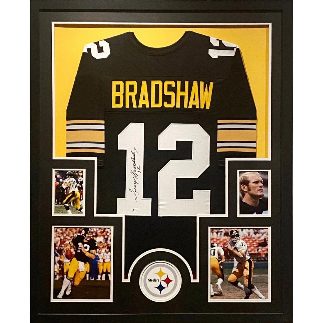 Beckett Authenticated Terry Bradshaw Autographed Framed Steelers Jersey: Beckett Authenticated Terry Bradshaw Autographed Framed Steelers Jersey Framed Terry Bradshaw autographed jersey featuring detailed presentation and a Pittsburgh Steelers logo display. The autograph i