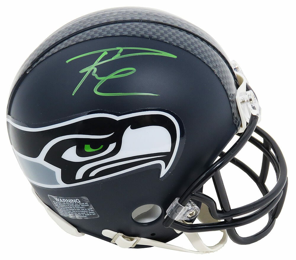 Russell Wilson Signed Seahawks Mini Helmet with Hologram COA: Russell Wilson Signed Seahawks Mini Helmet with Hologram COA This original signed mini helmet features Russell Wilson, the celebrated quarterback of the Seattle Seahawks. Ideal for football fans and c